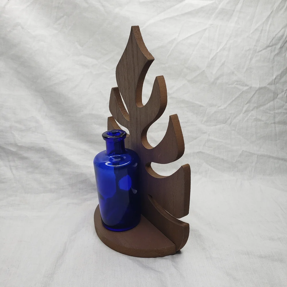 Wood Monstera Leaf Shelf With Blue Glass Vase